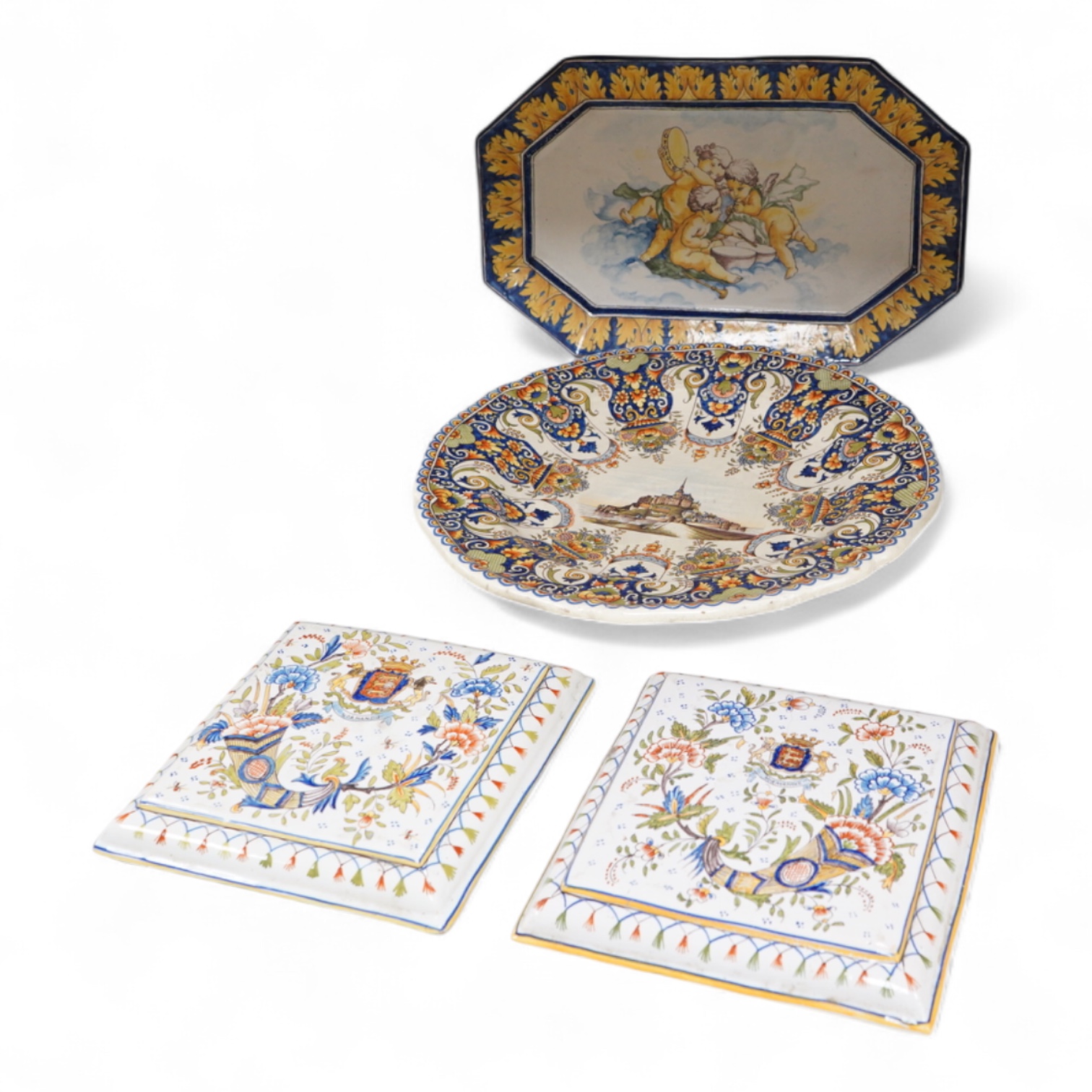 Four various late 19th century French faience dishes/stands, including a Nevers canted rectangular meat dish, largest 46cm wide